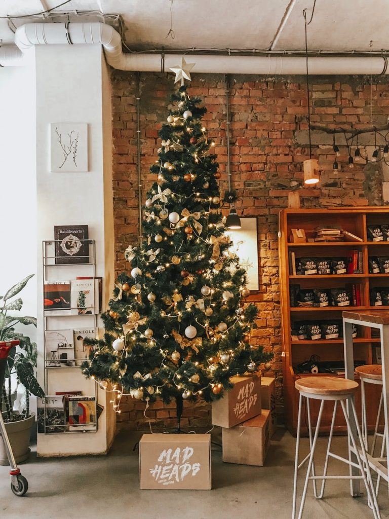 green and gold christmas tree near boxes inside room