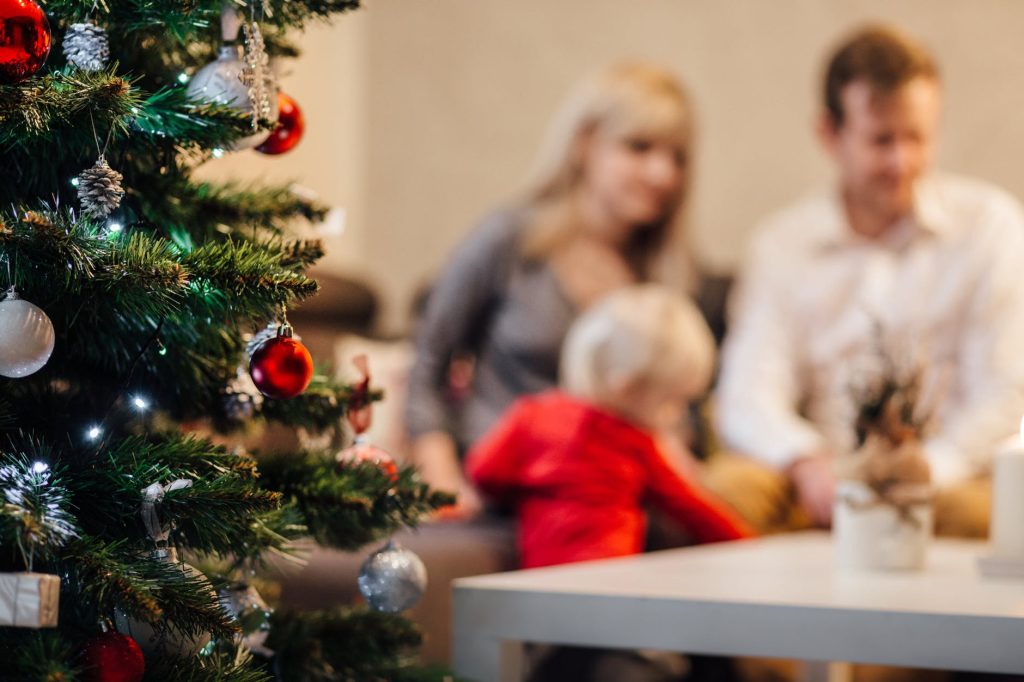 people on christmas tree at home during winter