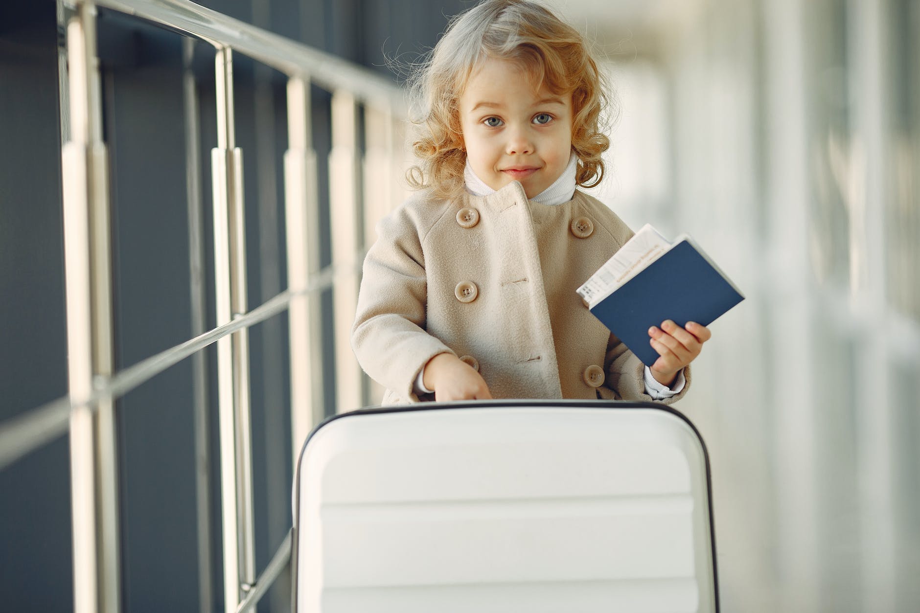 cute little girl with suitcase and passport